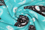 Swirled swatch Darth Vader Sugar Skulls fabric (light turquoise fabric with black darth vader heads with white floral drawing decor, sugar skull applique designs in background in white)
