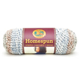 A ball of Lion Brand Homespun in a boucle texture and colourway Beachside Stripes (pale blue, white, sandy brown, light grey)