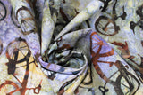 Swirled swatch Rusty Bikes fabric (marbled effect fabric in subtle blue, green, yellow colourway with tossed dark/rust look bikes allover)