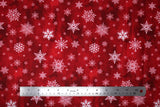 Flat swatch of snowflake printed fabric in wine (red marbled look fabric with white tossed snowflakes in various sizes and styles)