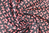 Swirled swatch licensed Minnie Mouse fabric in Minnie Dot Couture (red/white polka dot bows on black)