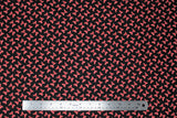 Flat swatch licensed Minnie Mouse fabric in Minnie Dot Couture (red/white polka dot bows on black)