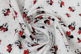 Swirled swatch licensed Minnie Mouse fabric in Dreaming in Dots (assorted minnie heads and grey polka dots on white)