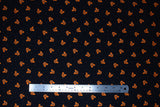 Flat swatch spooky ears fabric (black fabric with small tossed orange mickey head look jack-o-lanterns tossed allover with tiny orange polka dots)