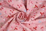 Swirled swatch MM Kitchen Magic fabric (pale pink fabric with tossed mickey and minnie mouse cartoon characters allover in chef/baking outfits with tossed food and kitchen tools)