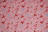 Flat swatch MM Kitchen Magic fabric (pale pink fabric with tossed mickey and minnie mouse cartoon characters allover in chef/baking outfits with tossed food and kitchen tools)
