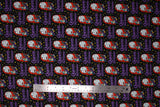 Flat swatch queen of screams fabric (black fabric with cartoon Sally character holding black cat "Queen of Screams" purple script beneath, repeated pattern with tiny tossed white and yellow dots and stars)