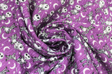 Swirled swatch Jack Stars fabric (purple fabric with white diagonal stripes and tossed stars and moons with tossed jack skellington characters allover)