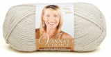 A ball of Lion Brand Vanna's Choice yarn on white background in shade linen (palest beige)