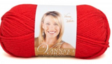 A ball of Lion Brand Vanna's Choice yarn on white background in shade scarlet (bright red)