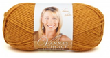 A ball of Lion Brand Vanna's Choice yarn on white background in shade honey (pale mustard yellow)