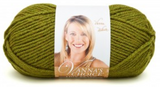 A ball of Lion Brand Vanna's Choice yarn on white background in shade fern (medium green)