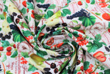 Swirled swatch Griotte Multi fabric (white fabric with tossed full colour fruits and red/brown cursive text)