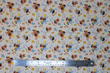 Flat swatch Howdy fabric (off white fabric with tossed cartoon cat and dog cowboys on blue horses and hobby horses with tossed cacti in yellow, blue and brown shades and lassos, "Hey Cowboy!" text)