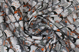 Swirled swatch cozy penguin stack fabric (tight collage rows of cartoon black and grey penguins with various winterwear on in green and orange colourway)