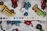 Raw hem swatch tossed trucks fabric (off white fabric with large full colour tossed assorted trucks in: red, green, blue, yellow)
