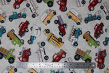 Flat swatch tossed trucks fabric (off white fabric with large full colour tossed assorted trucks in: red, green, blue, yellow)