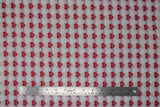 Flat swatch heartbeat fabric (grey fabric with alternating stripes of red hearts with red/white beat lines, and faint white hearts with beat lines)