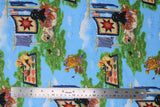 Flat swatch pups in the garden fabric (blue sky with white clouds background fabric with tossed green grass patches with cartoon golden and black lab puppies and clotheslines, bunnies, etc.)