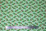 Flat swatch St. Patrick's Day themed fabric in cartoon leprechauns on light green
