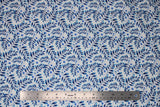 Flat swatch blue floral printed fabric in blue leaves on white