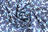 Swirled swatch blue floral printed fabric in hummingbirds (light blue tiny hummingbirds tiled on dark blue)