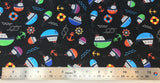 Flat swatch cartoon nautical printed fabric in black (black fabric with small tossed cartoon nautical emblems in full colour: boats, anchors, helms, knots, waves, life preservers)
