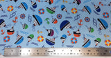 Flat swatch cartoon nautical printed fabric in light blue (light blue fabric with small tossed cartoon nautical emblems in full colour: boats, anchors, helms, knots, waves, life preservers)