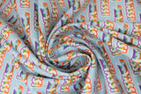 Swirled swatch Yass fabric (teal blue fabric with diagonal repeated "Yass!" text in white letting with rainbow dash horse running through)