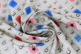 Swirled swatch Scrabble board fabric (white fabric with Scrabble board layout, tiles, etc. showing alphabet letters and word/letter score squares)