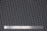Flat swatch The Office licensed printed fabric ("the office" text logo white on black)