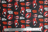 Flat swatch No Place To Hide fabric (black fabric with tossed "There is no place to hide" and "he's back" texts in red and white with small illustrative horror moments)