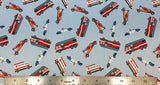 Flat swatch of cartoon emergency vehicle printed fabric in blue (pale light blue fabric with tossed cartoon police cars, firetrucks and ambulances)