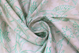 Swirled swatch Sun Print Luminance Flourish: Birds & Bugs fabric (white fabric with faint pink badge look stars allover and thin green outline drawings of birds and insects allover with tossed outline stars)