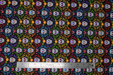 Flat swatch Sugar Skull Stripe fabric (black fabric with colourful swirly greenery look decor allover in lines of colour: pink, blue, purple, yellow, orange with brightly coloured sugar skulls inside)