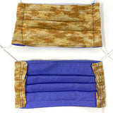 Front and back view of mask with white elastic ear loops (pale brown mask with medium brown marbled look print)