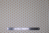 Flat swatch Sharkies fabric (white fabric with scattered lines of tiny orange shark silhouettes)
