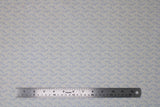 Flat swatch dreamy leaf fabric (cream coloured fabric with subtle pale blue swoopy greenery style leaves allover)