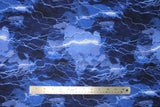 Flat swatch cracking lightning bolts fabric (light to dark blue coloured fabric mimicking stormy sky with bright lightning lines allover)