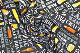 Swirled swatch Grab Me A Beer fabric (black fabric with horizontal and vertical text allover in white with beer related words "Ale" "IPA" "Hops" etc. and assorted beer glasses, steins and bottles)