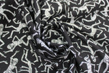 Swirled swatch Dancing Mummies fabric (black fabric with tossed dancing white mummies allover)