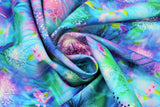 Swirled swatch Ethereal Dandelions fabric (blues, greens and purples toned fabric with dandelions allover in various colours)