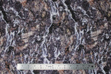 Flat swatch nature themed fabric grey/brown rock face texture with white water