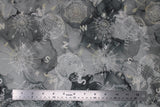 Flat swatch journey themed fabric in compass toss (medium to dark grey watercolour marbled fabric with light grey compass and globe tossed outlines, directional letters)