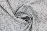 Swirled swatch journey themed fabric in airplane texture white (white fabric with light grey solid airplane shapes tiled/criss crossing)