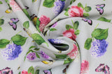 Swirled swatch floral toss fabric (pale grey fabric with tossed pink, purple, white floral with green leaves and stems, and small tossed butterflies in yellow, pink, purple colours)