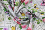Swirled swatch stamps fabric (pale grey fabric with white stamps collaged allover with greenery, floral and butterflies allover in green, pink, purple, yellow, white colours)