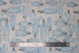 Flat swatch message in the bottle fabric (neutral coloured fabric with tossed blue bottles with white scrolls inside, cork topper)