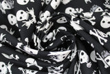 Swirled swatch skulls fabric (rock and roll style white skull heads tossed on black, some are regular, some have bandanas or crossing guitars for bones, etc.)