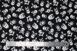 Flat swatch skulls fabric (rock and roll style white skull heads tossed on black, some are regular, some have bandanas or crossing guitars for bones, etc.)